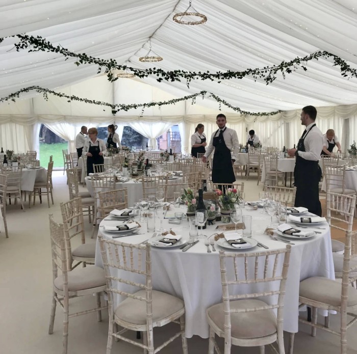 Staff laying up a marquee